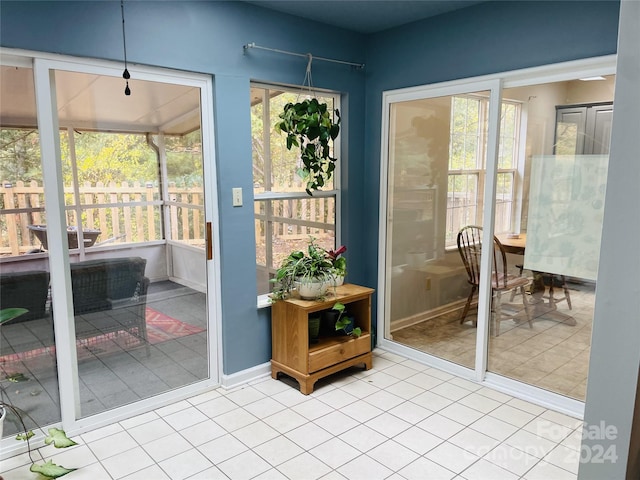 doorway to outside with light tile patterned flooring