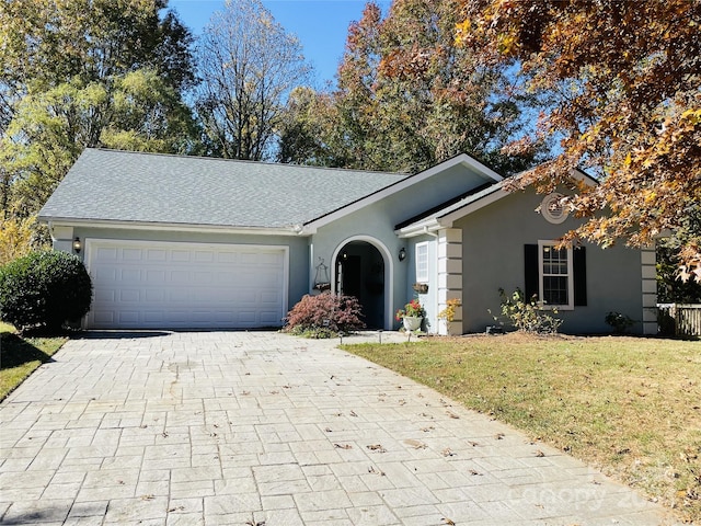 ranch-style house with a garage and a front yard