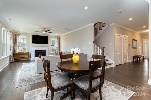 dining room featuring ornamental molding, dark hardwood / wood-style flooring, and ceiling fan