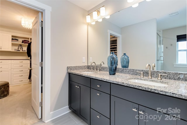 bathroom featuring walk in shower and vanity