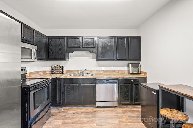 kitchen featuring sink, stainless steel appliances, and light hardwood / wood-style flooring