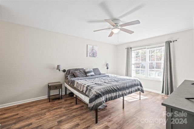 bedroom with ceiling fan and dark hardwood / wood-style flooring