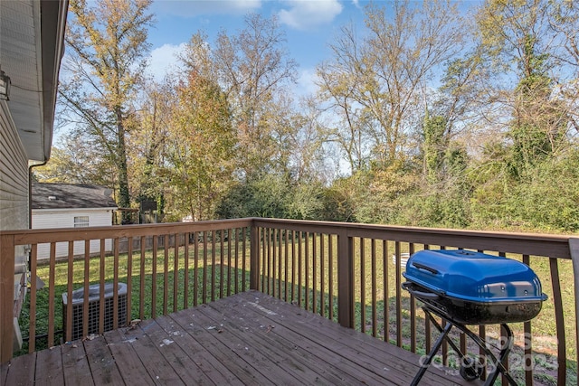 deck with a lawn and grilling area