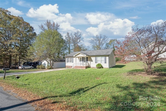 ranch-style house with covered porch and a front yard