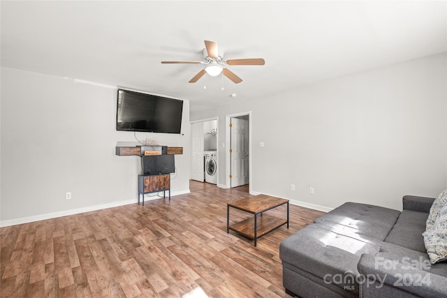 living room with washing machine and dryer, ceiling fan, and light hardwood / wood-style flooring