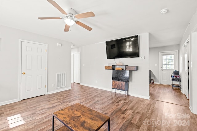 living room featuring hardwood / wood-style floors and ceiling fan