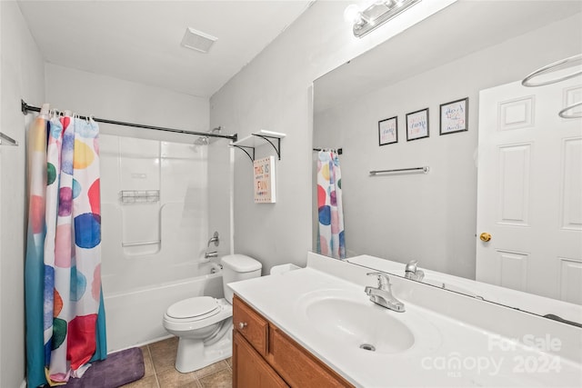 full bathroom with tile patterned floors, shower / tub combo with curtain, vanity, and toilet