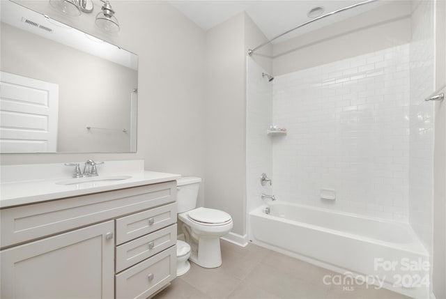 full bathroom featuring toilet, vanity, tiled shower / bath, and tile patterned floors