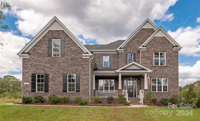 craftsman-style home featuring a porch and a front lawn