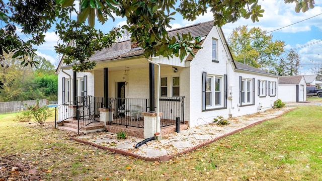 view of front of house featuring a front yard and covered porch