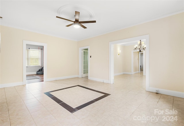 tiled spare room featuring ceiling fan with notable chandelier and ornamental molding