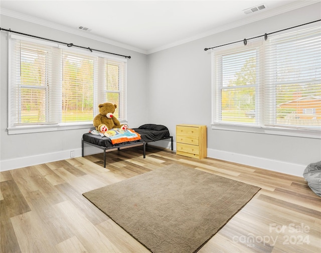 sitting room with hardwood / wood-style flooring and ornamental molding