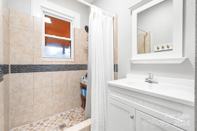 bathroom featuring vanity and curtained shower