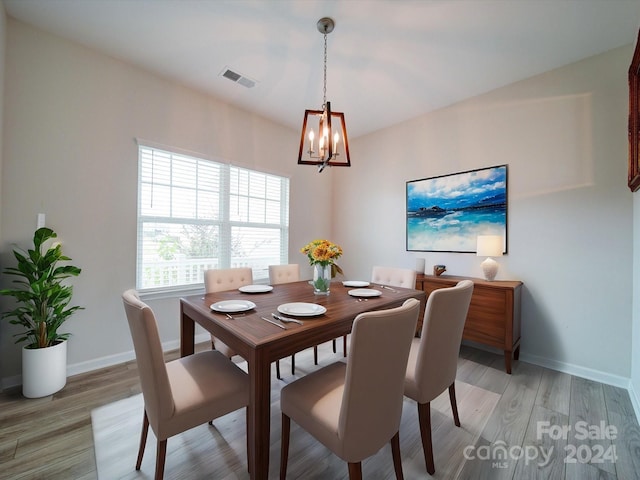 dining room with a chandelier and light hardwood / wood-style flooring