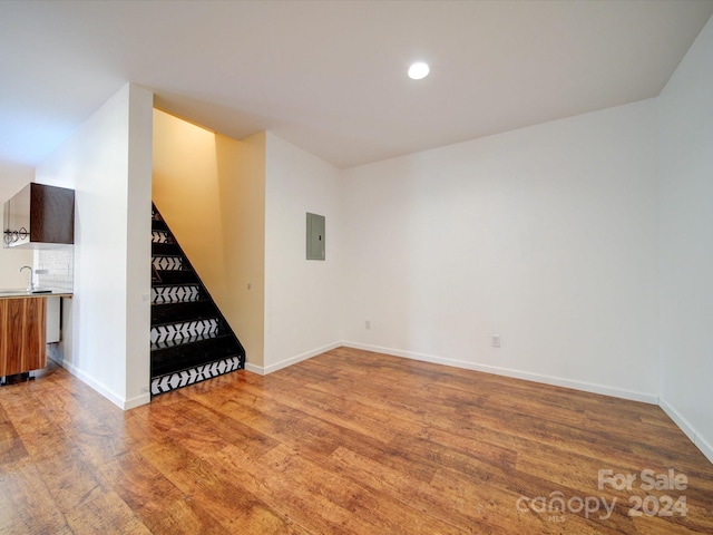 interior space featuring electric panel and wood-type flooring