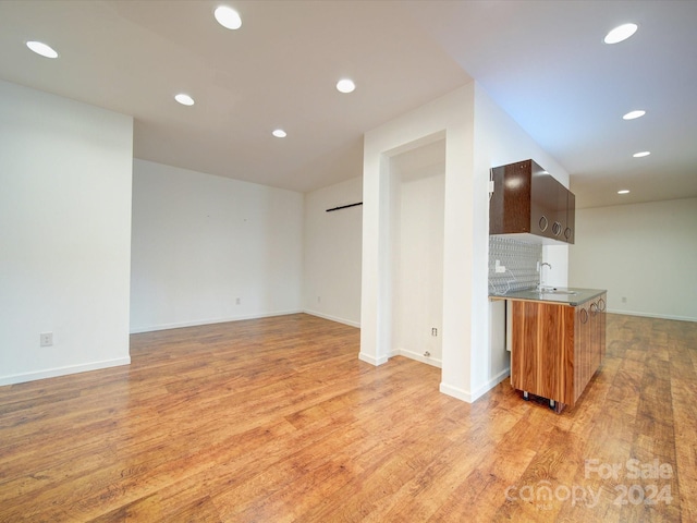 kitchen with light hardwood / wood-style flooring and tasteful backsplash