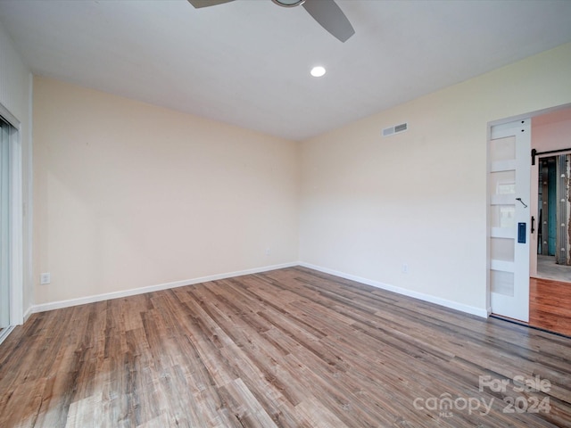 empty room featuring wood-type flooring and ceiling fan