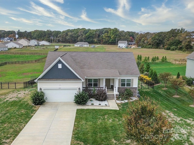 view of front of property featuring a front lawn, a garage, and covered porch