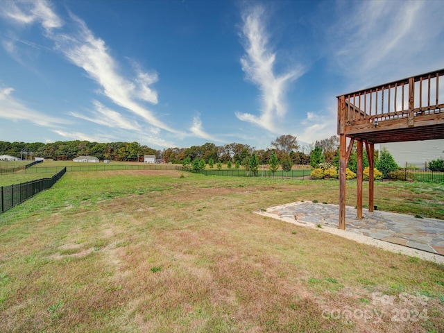 view of yard featuring a deck and a rural view