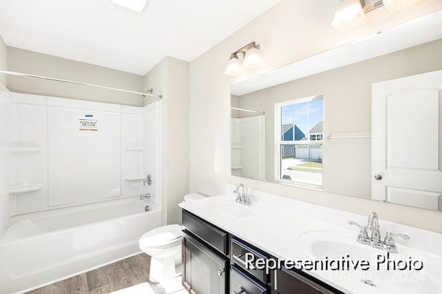 full bathroom featuring  shower combination, vanity, toilet, and hardwood / wood-style floors