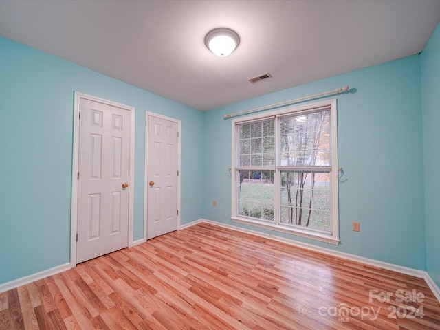 unfurnished bedroom with light wood-type flooring