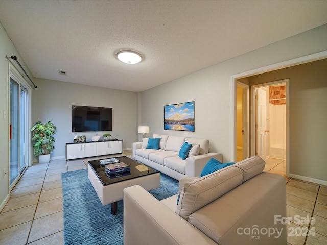 living room featuring light tile patterned floors and a textured ceiling