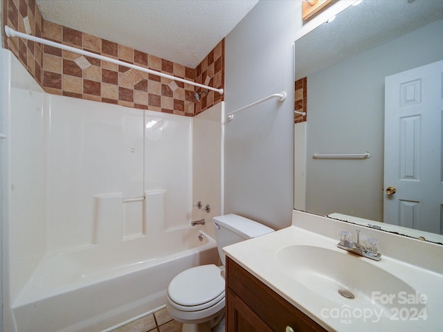 full bathroom with tile patterned floors, a textured ceiling, toilet, shower / washtub combination, and vanity