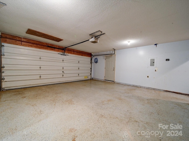 garage featuring electric panel and a garage door opener