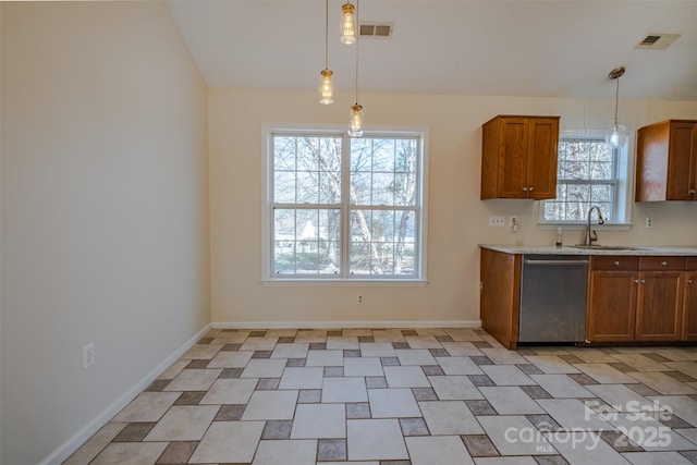 kitchen with a sink, visible vents, stainless steel dishwasher, and light countertops