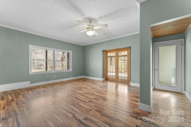 spare room featuring french doors, hardwood / wood-style floors, and a wealth of natural light