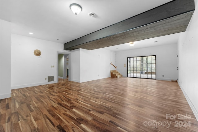 unfurnished living room with wood-type flooring