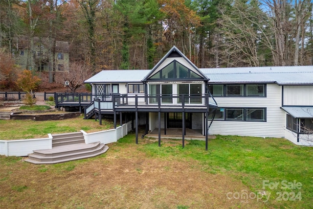 back of house featuring a yard and a wooden deck