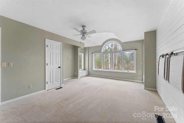 unfurnished room featuring light carpet and ceiling fan