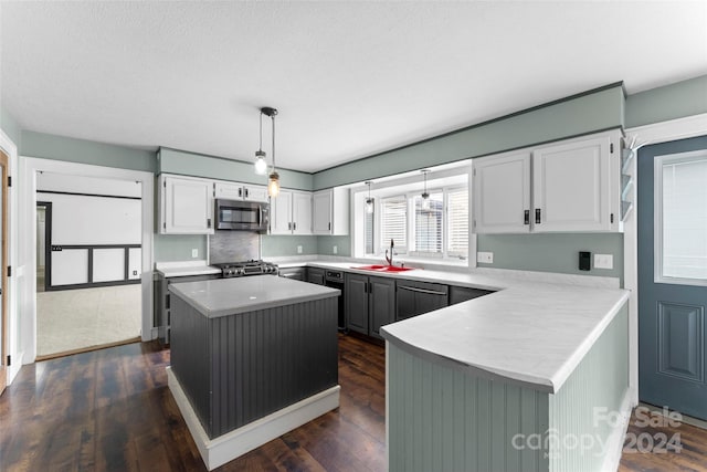 kitchen with a kitchen island, pendant lighting, white cabinetry, and stainless steel appliances