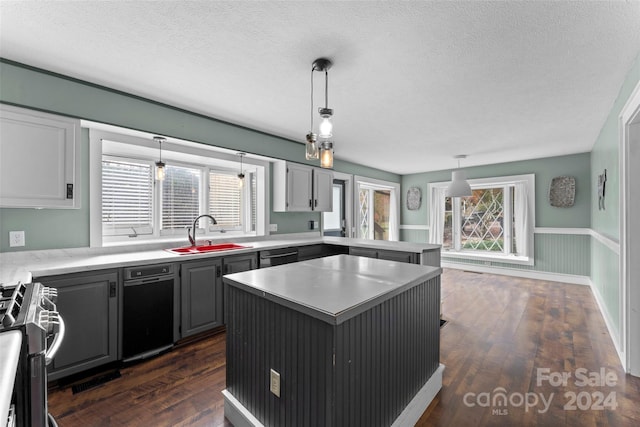 kitchen featuring dark hardwood / wood-style flooring, a kitchen island, sink, and a textured ceiling