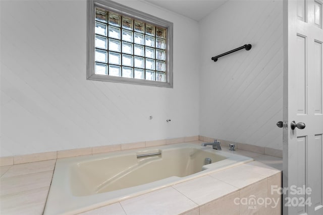 bathroom with a relaxing tiled tub