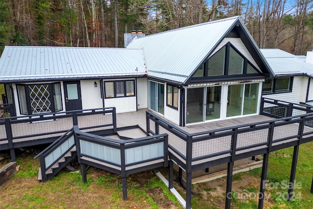 rear view of house featuring a deck