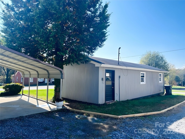 exterior space with a lawn and a carport