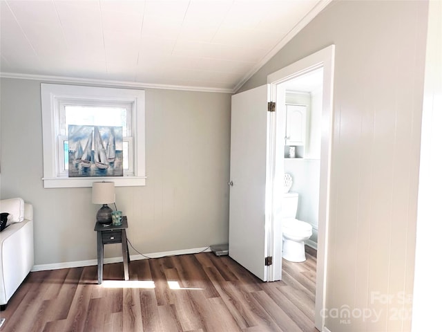 interior space with hardwood / wood-style floors, lofted ceiling, and crown molding