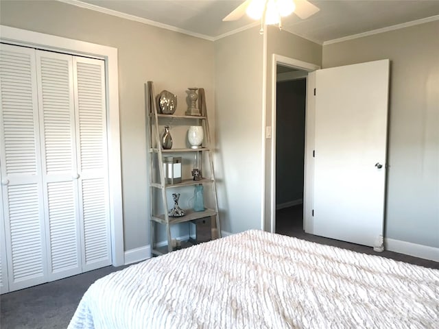 bedroom featuring ornamental molding, a closet, dark colored carpet, and ceiling fan