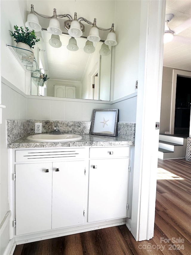 bathroom with hardwood / wood-style flooring and vanity