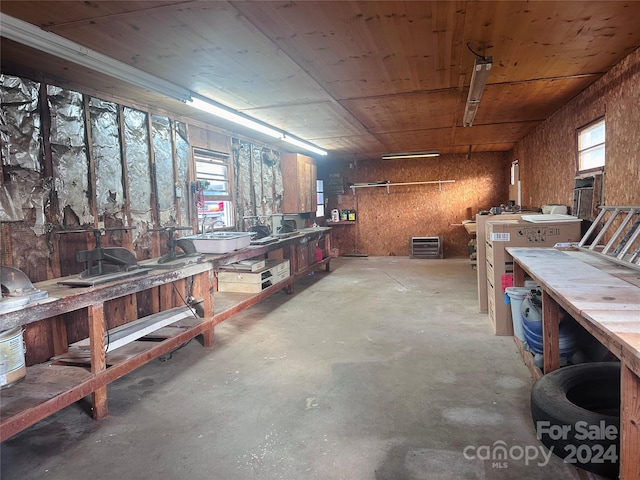 miscellaneous room featuring a workshop area and concrete flooring