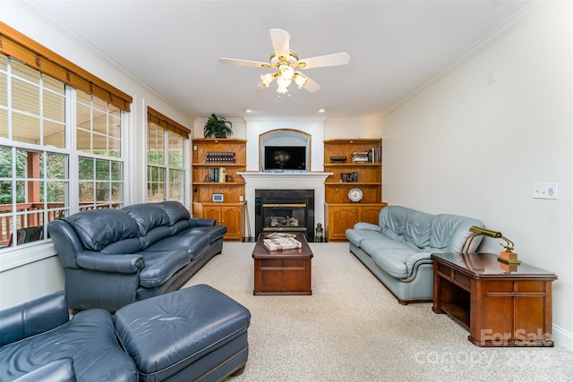 carpeted living room with ceiling fan and crown molding