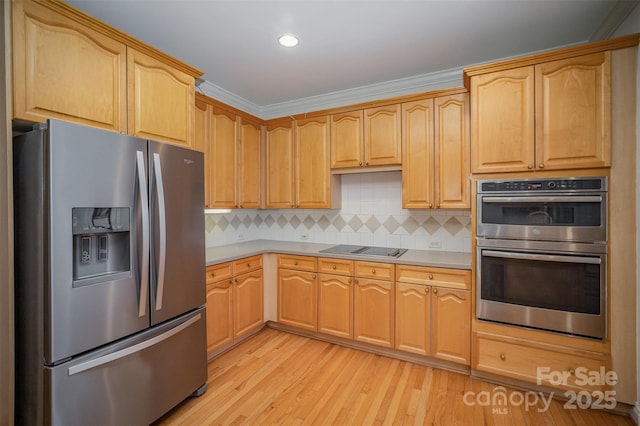 kitchen with light brown cabinetry, decorative backsplash, crown molding, and stainless steel appliances