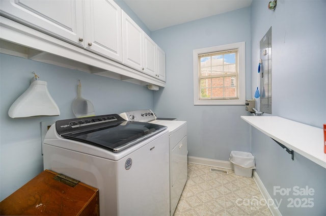 laundry area with washer and dryer and cabinets