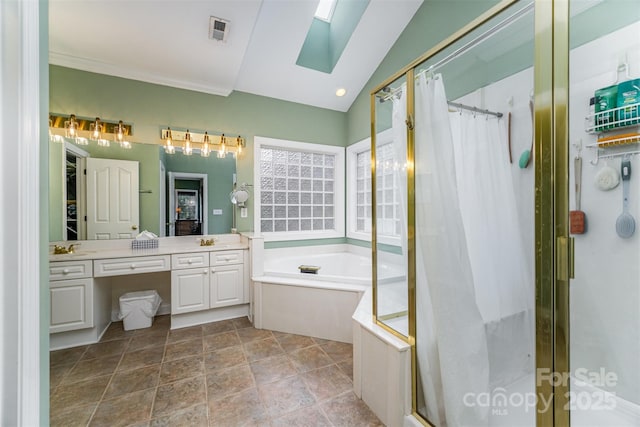 bathroom with vaulted ceiling with skylight, vanity, and separate shower and tub