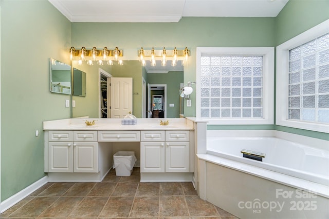 bathroom featuring crown molding, vanity, and a washtub