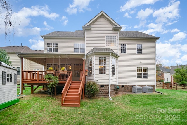 rear view of property with central AC unit, a deck, and a yard