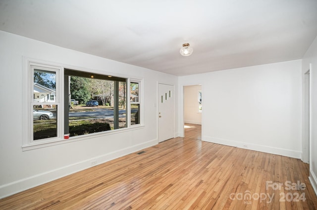 spare room featuring light wood-type flooring