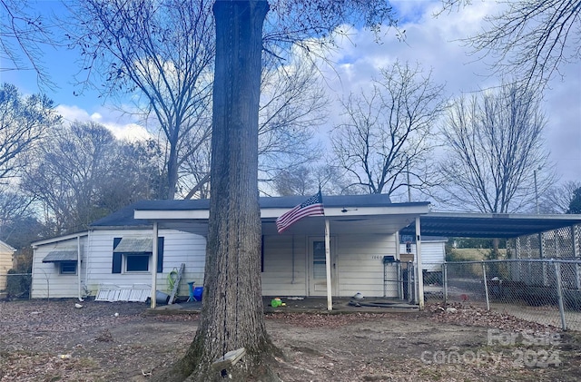 rear view of house with a carport and covered porch